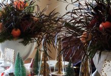 dinner table decorated with miniature Christmas trees