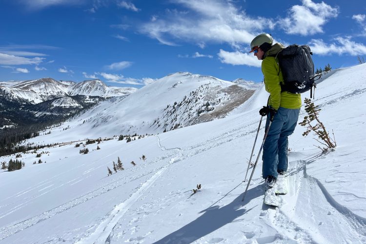 Trekking across snowy mountain face
