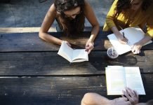 Starting Your Own Book Club People sitting around picnic table with books