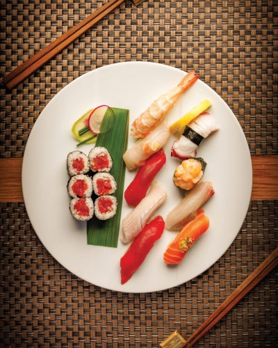 Tuna roll and assorted seasonal nigiri including shrimp, red snapper, bluefin tuna, yellowtail, octopus, scallop, amberjack, and king salmon.