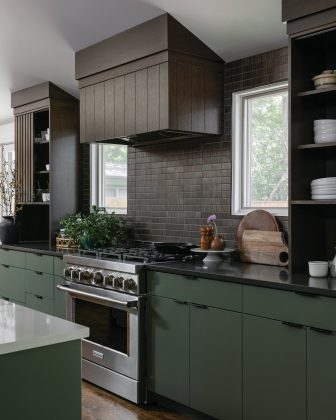 Kitchen stove and cabinets area by Forge & Bow Dwellings