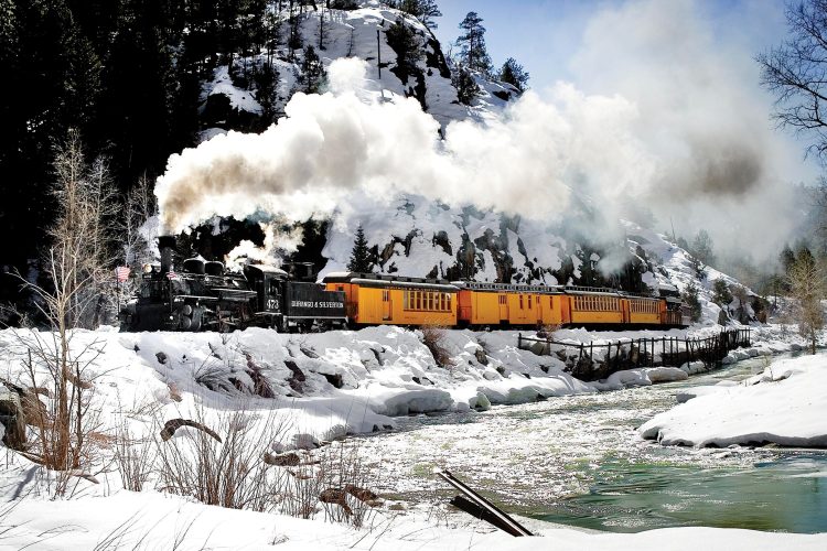 Cascade Canyon Winter Train runs through the mountains along the river. 