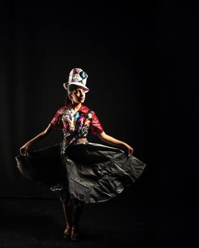 Woman wearing dress made out of trash