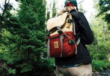 Person hiking through the forest with a Topo Designs backpack