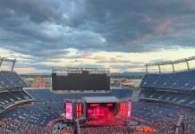 Fans face the stage while attending a concert at Empower Field at Mile High