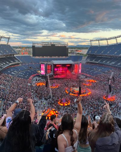 Fans face the stage while attending a concert at Empower Field at Mile High