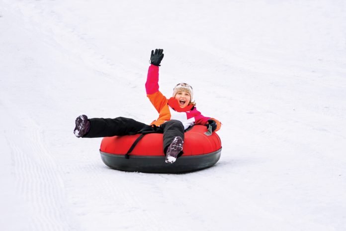 Kid tubing down Hoedown Hill