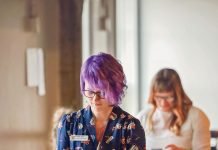 Woman browses through books.