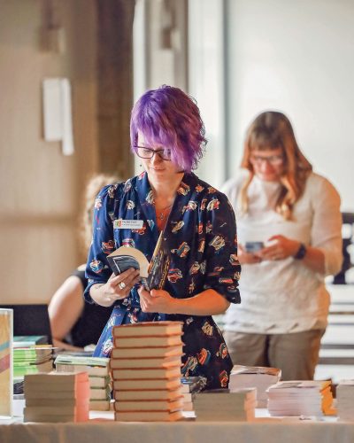 Woman browses through books. 