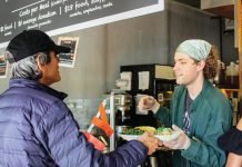 Man is served meal at SAME Café.