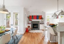 View of whole kitchen area, dining area, mudroom, and fireside nook by designer Jennifer Rhode.