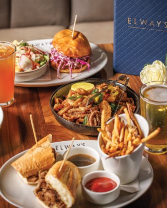 The fish sandwich with house salad, Rhode Island-style calamari, light beer, prime rib sandwich with fries, and Arnold Palmer at Elways.