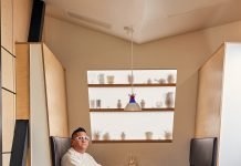 Kevin Nguyen sits at a table at Hey Kiddo restaurant.