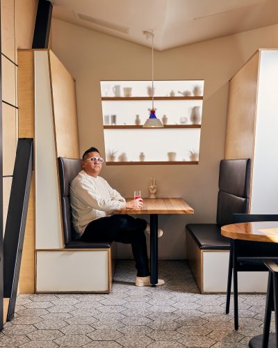 Kevin Nguyen sits at a table at Hey Kiddo restaurant.
