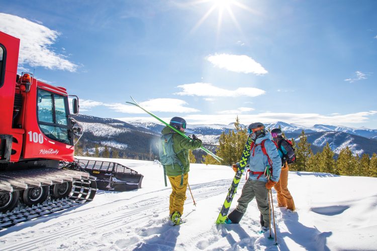 Skiers stand near a snowcat at Devil's Thumb Ranch.