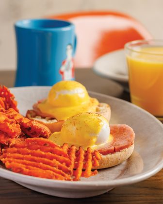 The classic eggs Benedict and sweet potato waffle fries, orange juice, and a coffee at Bacon Social House.