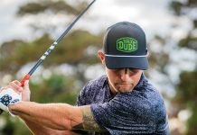 A man golfs while wearing items from the Pins & Aces X Hey Dude collaboration.