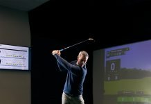 Patrick Nuber practices in a golf simulator.