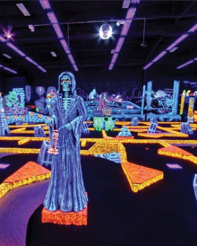 People golfing at Monster Mini Golf.