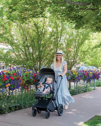 Woman walks down the street with a stroller in Aspen, CO.