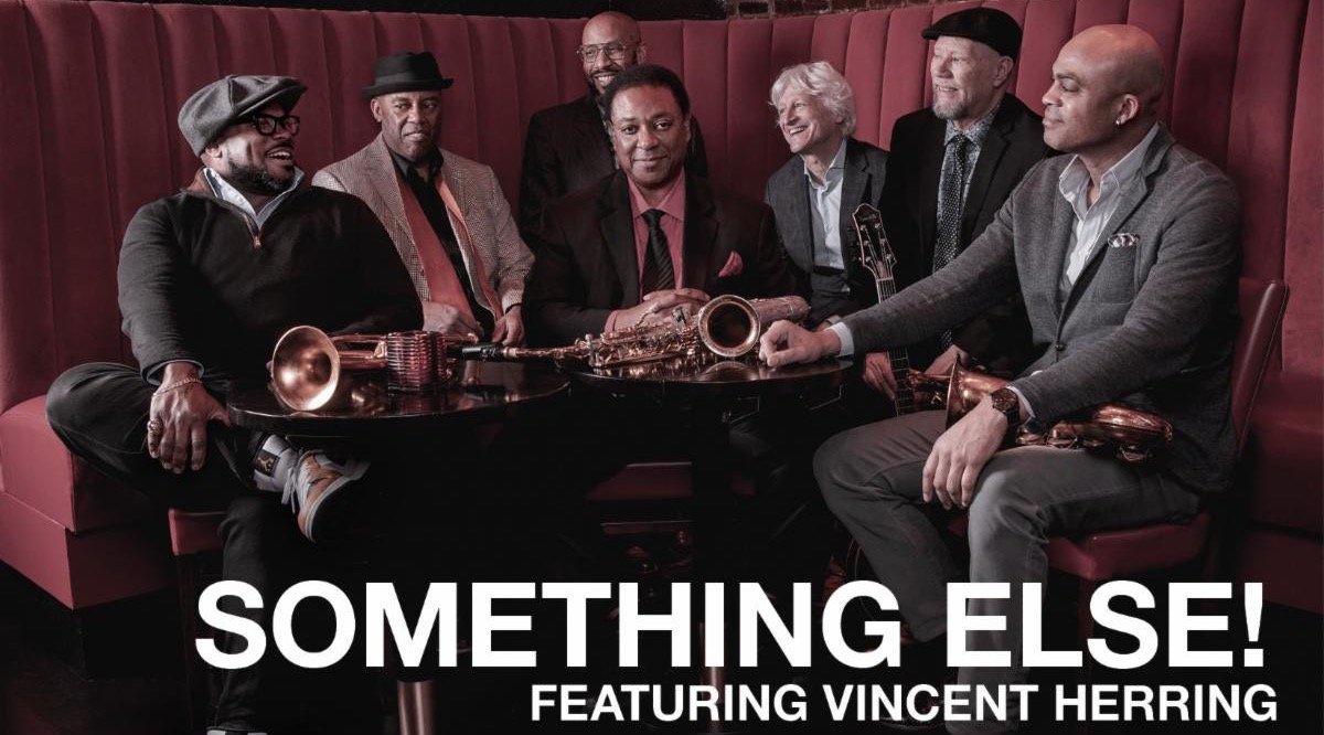 The seven members of Something Else! sitting with their instruments