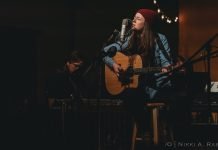 Brianna Straut playing guitar.