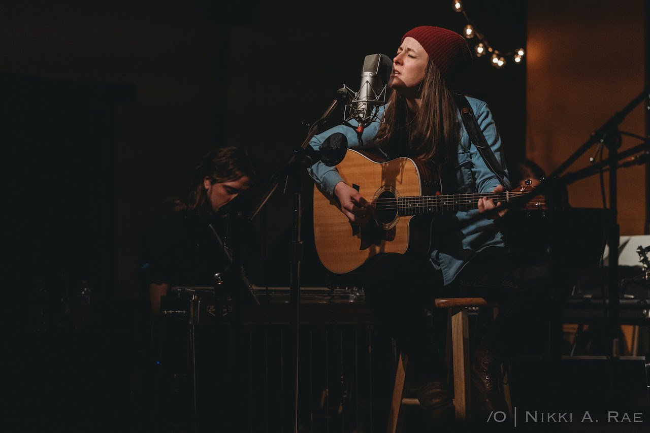 Brianna Straut playing guitar.