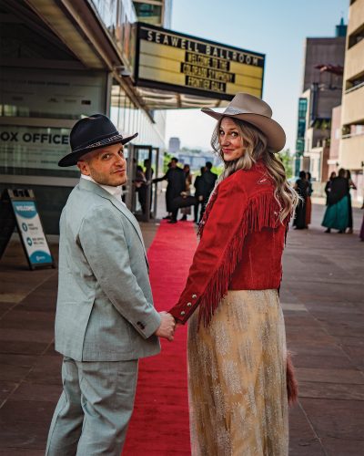 Dan and Alicia walk hand in hand through the streets of Denver.