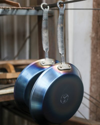 Skillets hang in blacksmith shop