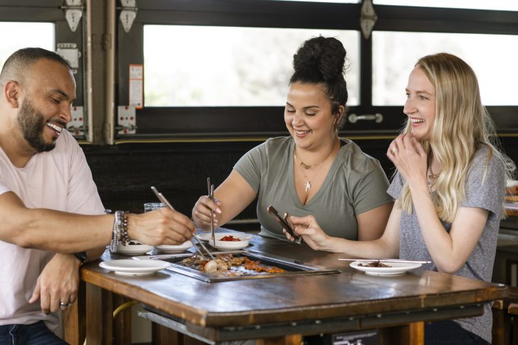 People share a meal at the City of Aurora