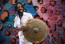 Paa Kow with a cymbal and drum sticks