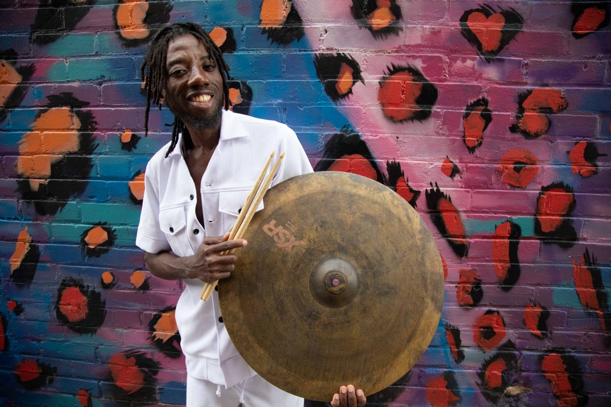 Paa Kow with a cymbal and drum sticks