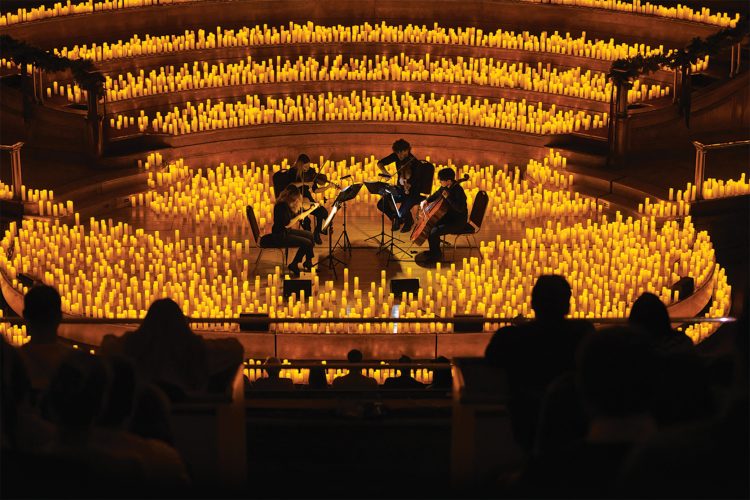A band plays surrounded by candles at a Candlelight concert.