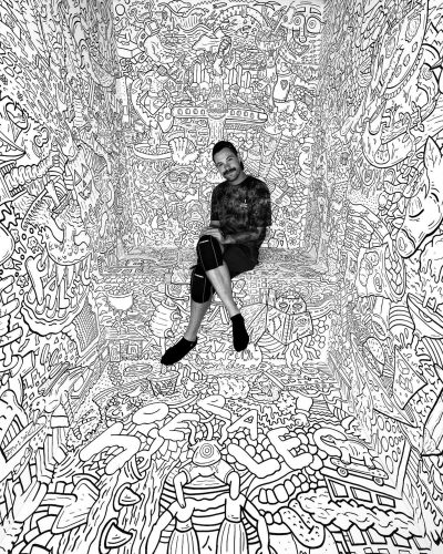 Joe Palec poses in front of his work 