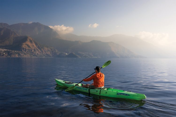 A man kayak's while wearing Tellus gear.