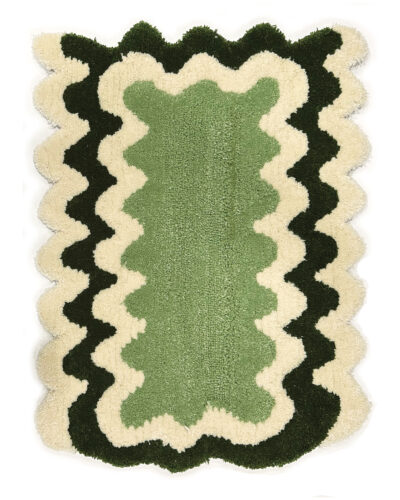Green and white wavy rug made by a student at Tuft Love's classes.