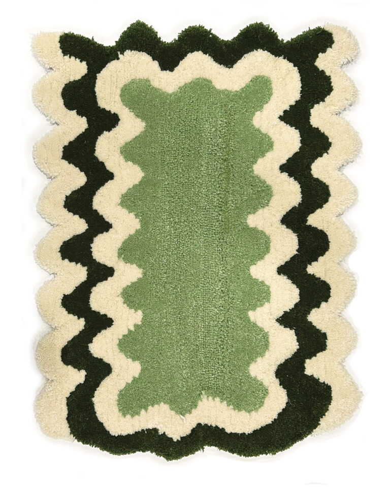 Green and white wavy rug made by a student at Tuft Love's classes.