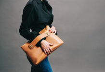 Apposé Creates Luxury Handbags for Life on the Move Model poses with an Apposé bag.