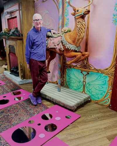 Lonnie Hanzon poses with one of his Camp Christmas displays.