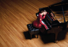 St. John Delia Gown in Velvet Sequin, $2,495, available at St. John, 224 Steele St., stjohnknits.com; Gloves, stylist’s own; Elegant constellation diamond tennis necklace, $14,190; Cross-over diamond ring with yellow pear-shaped diamond, $19,250; “Latis” lab-grown diamond tennis bracelet by Noam Carver Fine Jewelry, $11,965; Diamond chandelier earrings, $8,360. All jewelry available at Trice Jewelers, 6885 S. University Blvd., Centennial, tricejewelers.com.