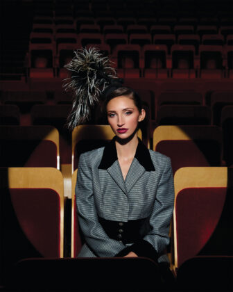 Black and white “Phyliss” percher hat, $80, available by Miss Victoria Regina, The Haberdashery, 4150 Fox St., Unit B1, missvictoriaregina.com; Jacques Fath Paris for Neiman Marcus two-piece black striped jacket and skirt with velvet trim and rhinestone buttons, price upon request