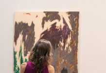 Woman admires painting at Clyfford Still Museum.