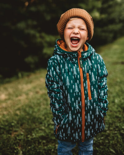 Child posing in Keep the Littles Wild outdoor gear.