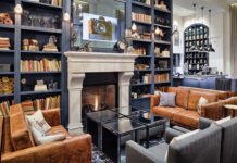 A Stay at Hotel Teatro Blends History, Theater, and Modern Comfort The lobby area with fireplace and bookshelf at Hotel Teatro.