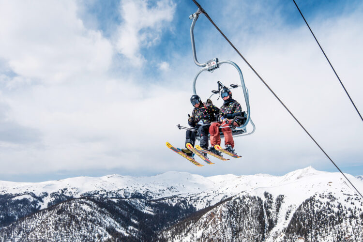 Two skiers ride the chairlift at Arapahoe Basin.