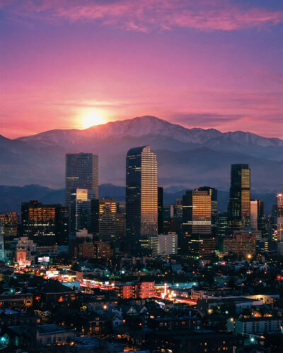 The Denver skyline against the mountains at sundown.