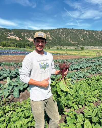 Casey Piscura poses in a field with beets.
