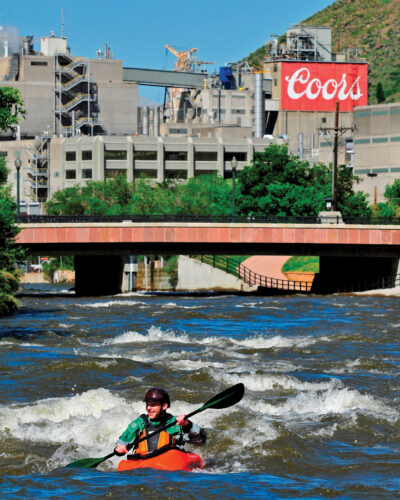 Person kayaks in Golden, CO.