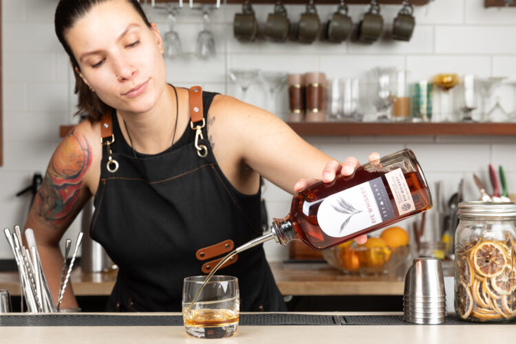 Bartender pours Dry Land Distillers product into a drink.