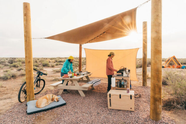 People relax in the kitchen and picnic area at Ramble Camp.